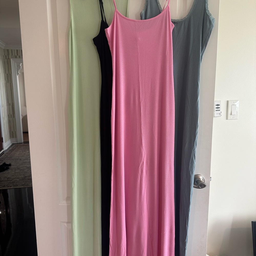 SKIMS Maxi Slip Dresses in Pink, Black, Light Green, and Gray